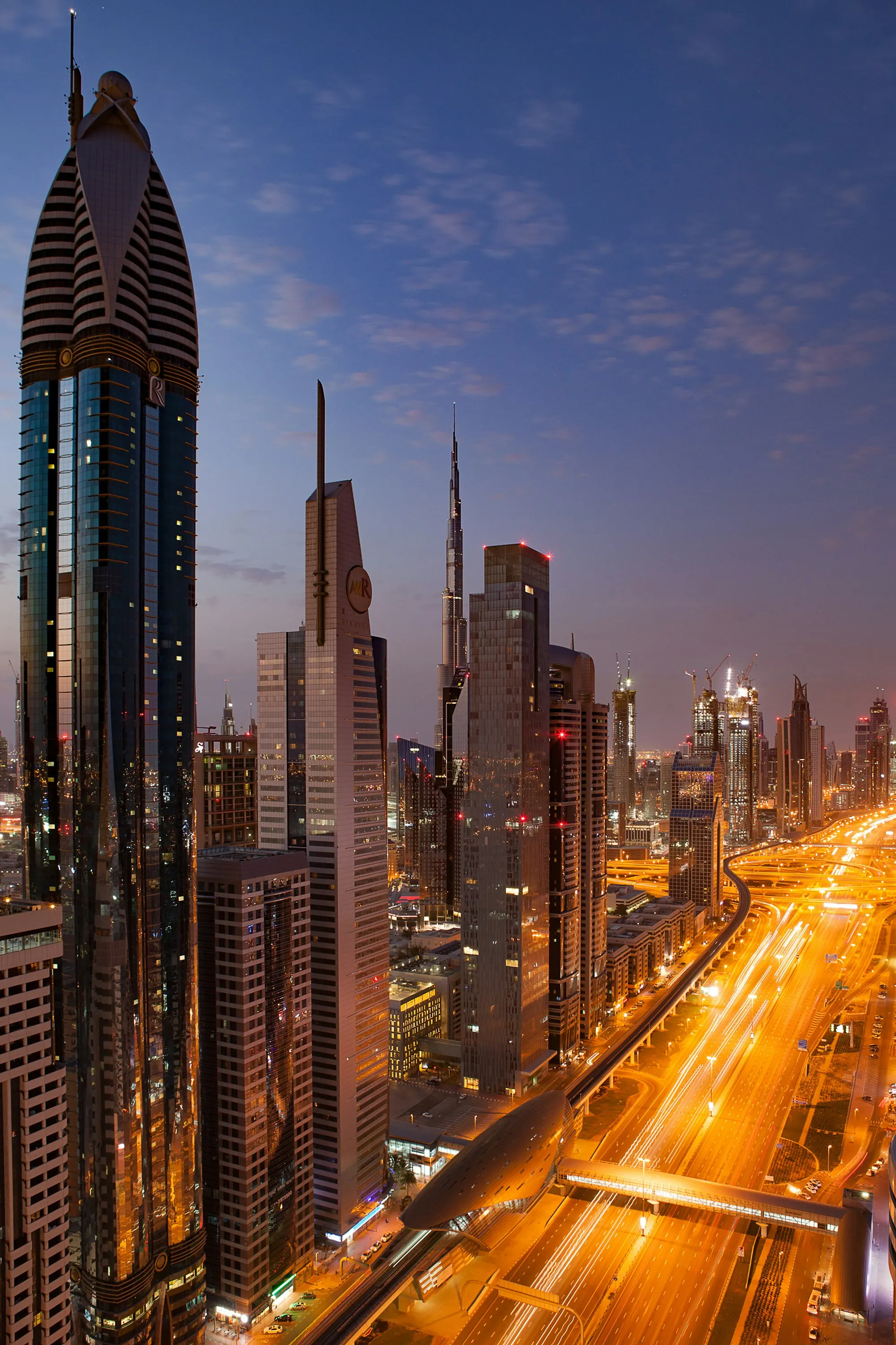 Dubai towers lit up at dusk